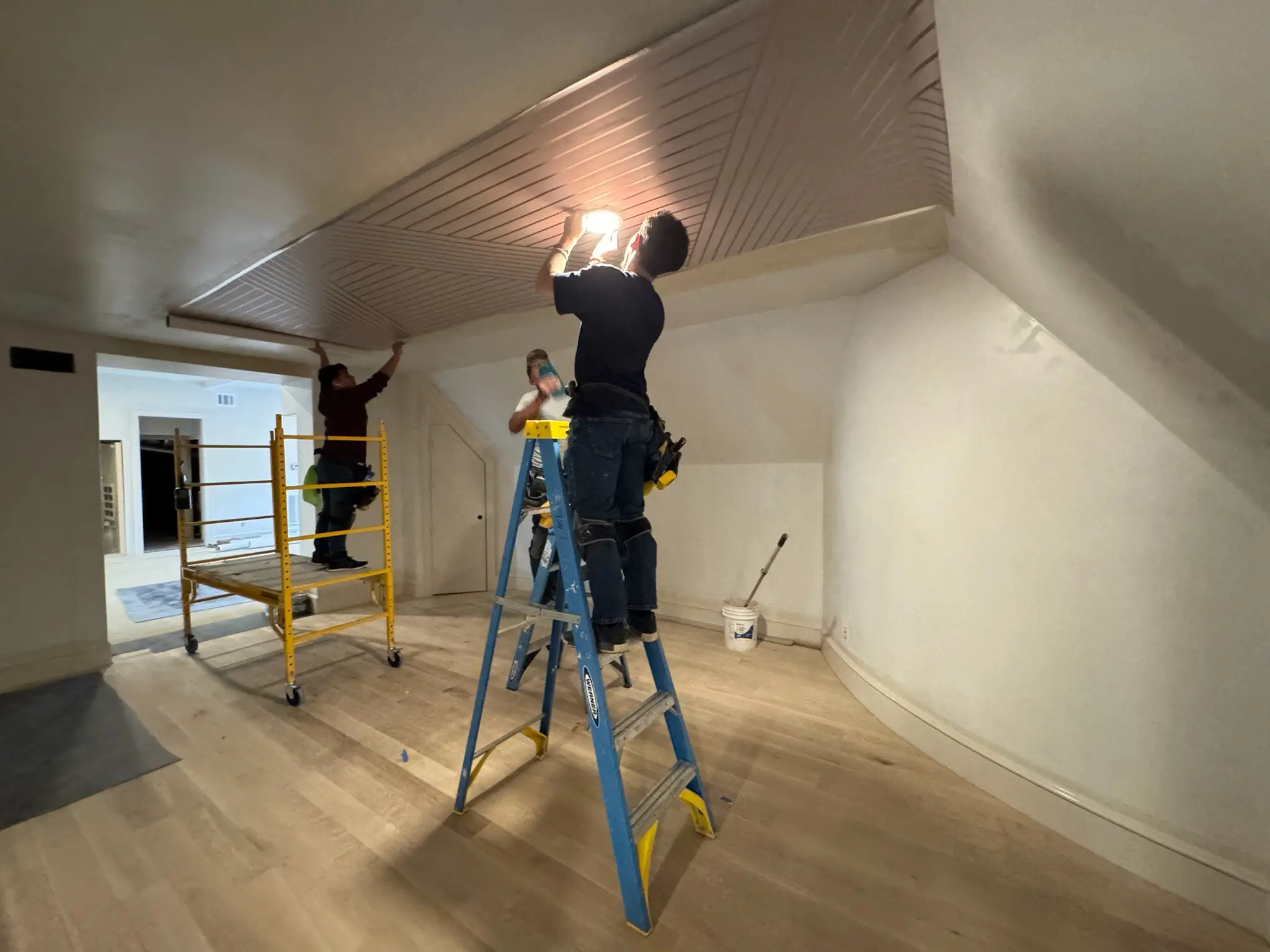 Professional wallpaper installer applying elegant wallpaper in a modern Washington DC home